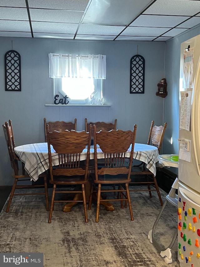 dining space with a drop ceiling