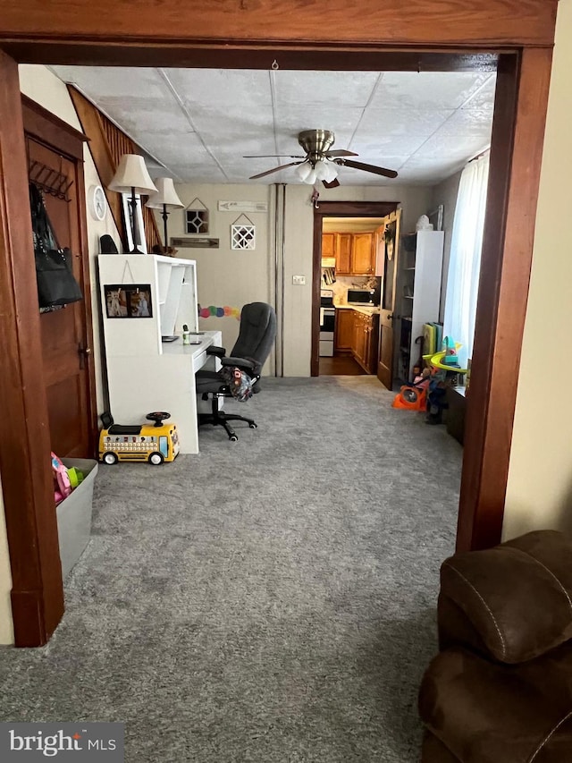 carpeted office with ceiling fan