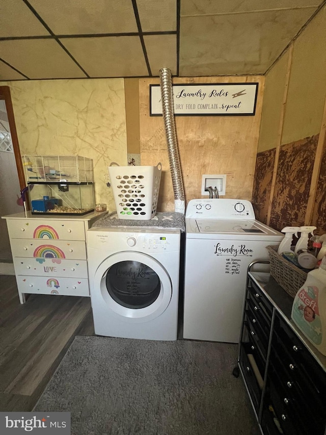 clothes washing area with dark hardwood / wood-style flooring and separate washer and dryer