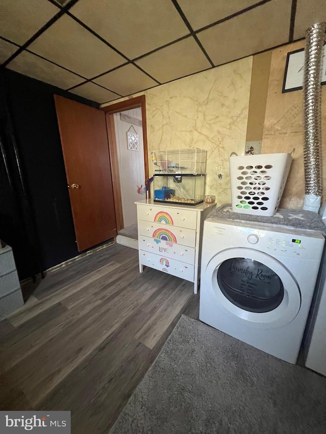 laundry area with dark hardwood / wood-style flooring and washing machine and clothes dryer