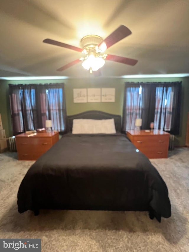 carpeted bedroom with ceiling fan