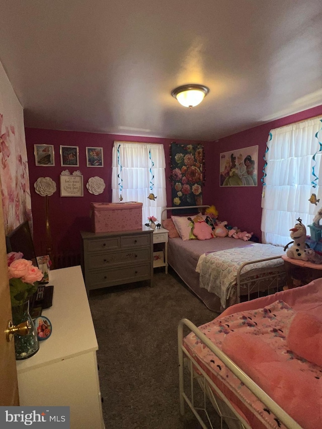 bedroom featuring dark colored carpet