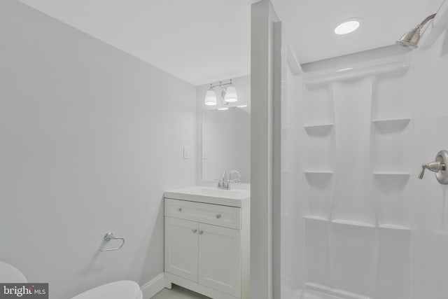 bathroom featuring a shower, vanity, and toilet