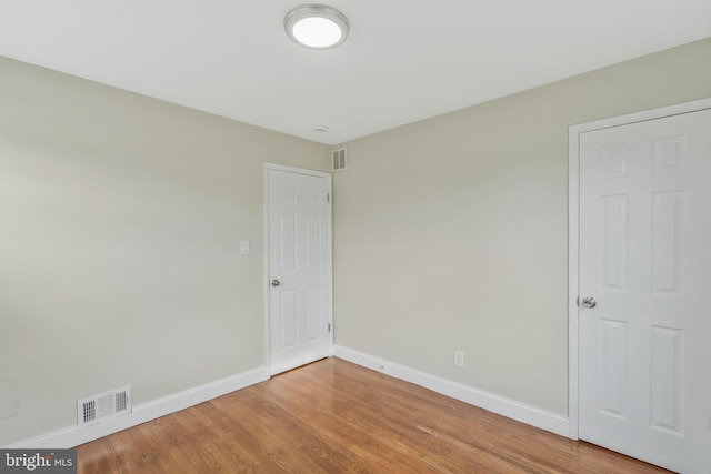 spare room with hardwood / wood-style floors