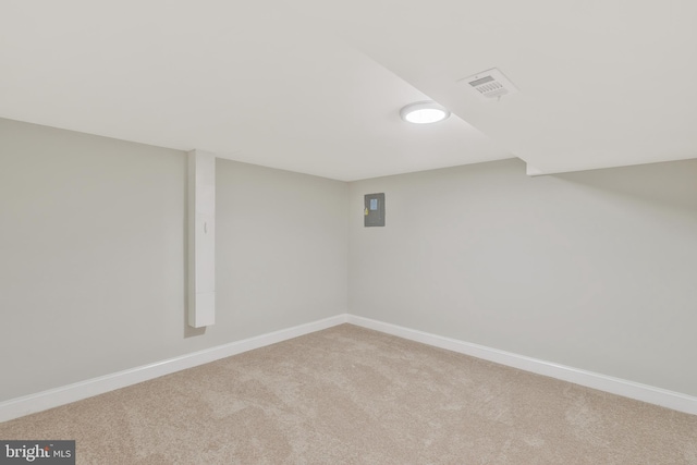 basement with carpet flooring and electric panel