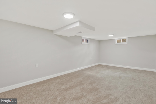 basement featuring light colored carpet