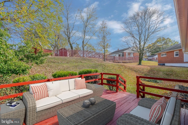 wooden terrace featuring outdoor lounge area and a yard