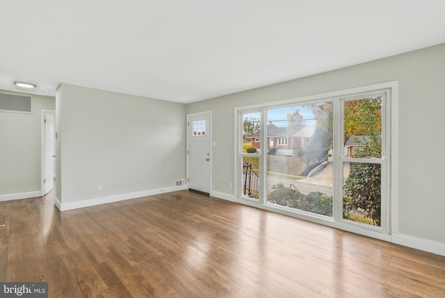 spare room with hardwood / wood-style floors