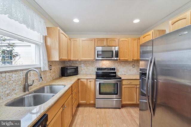 kitchen with decorative backsplash, sink, stainless steel appliances, and ornamental molding