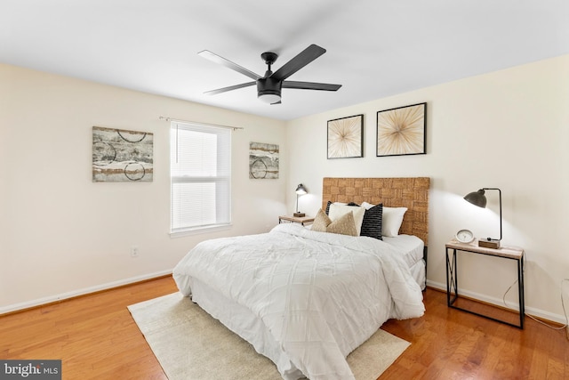 bedroom with ceiling fan and wood-type flooring