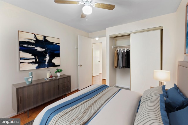 bedroom with light hardwood / wood-style flooring, a closet, and ceiling fan