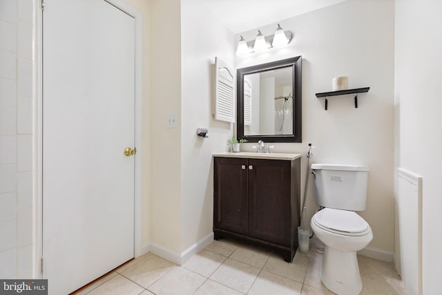 bathroom featuring tile patterned floors, vanity, and toilet