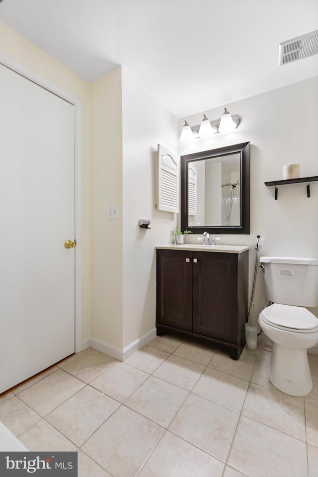 bathroom with tile patterned floors, vanity, and toilet