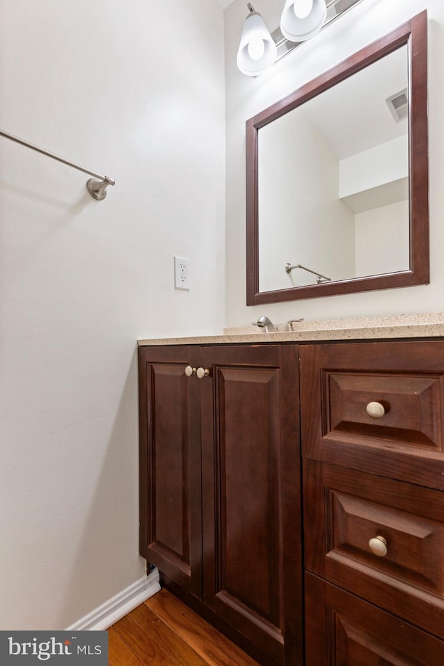 bathroom featuring hardwood / wood-style flooring and vanity