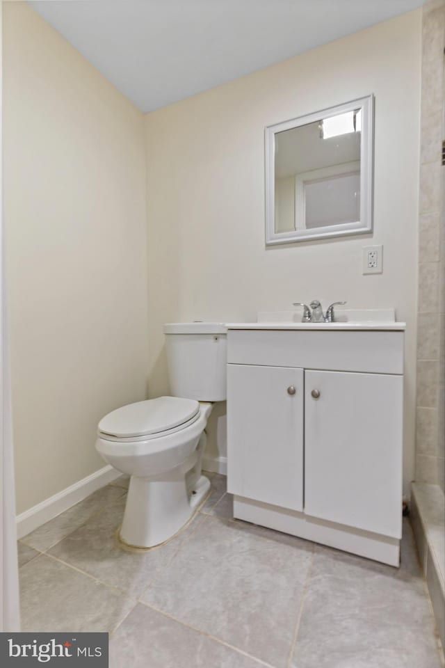 bathroom featuring tile patterned floors, vanity, and toilet