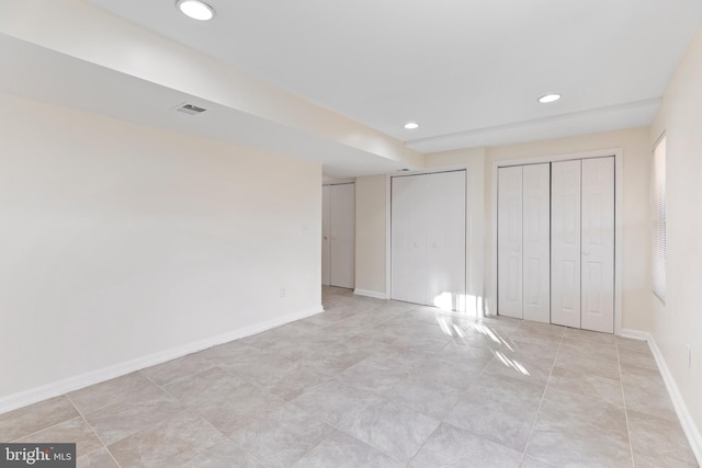 unfurnished bedroom featuring two closets