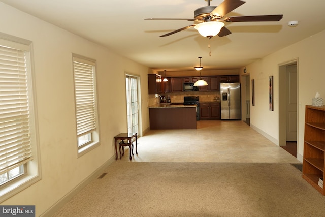 unfurnished living room with light colored carpet and ceiling fan