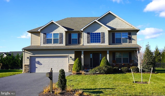 view of front of house featuring a front yard and a garage