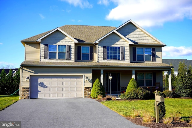 craftsman-style house featuring a porch, a garage, and a front lawn