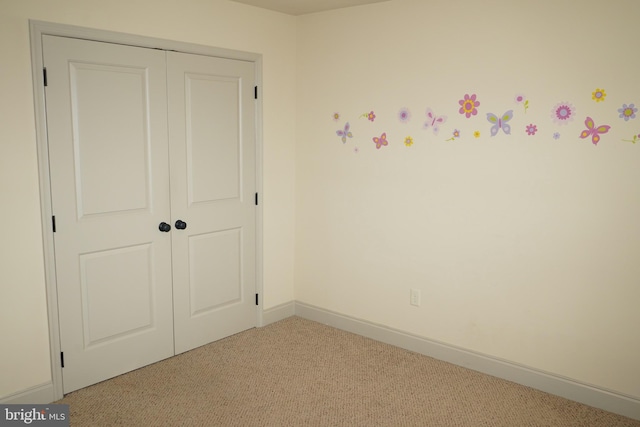 unfurnished bedroom with light colored carpet