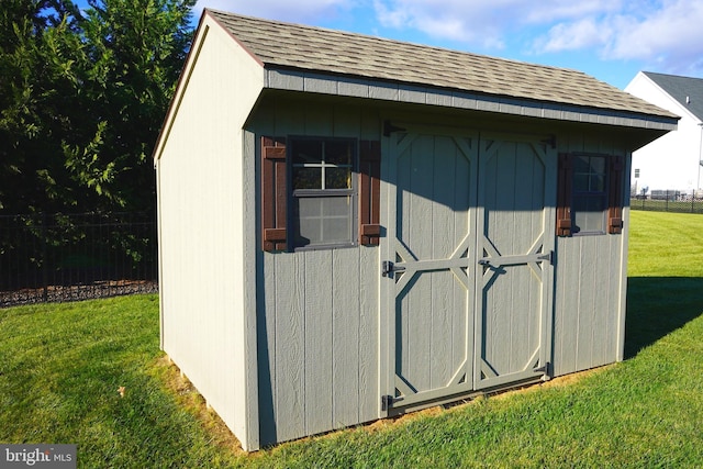 view of outbuilding featuring a lawn