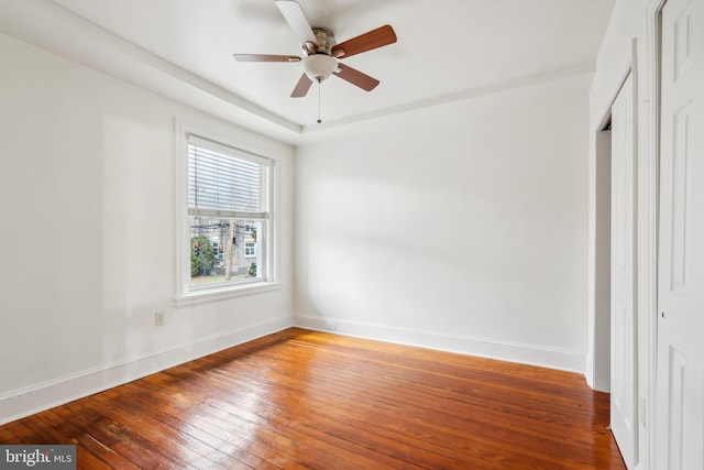 unfurnished bedroom with ceiling fan and wood-type flooring