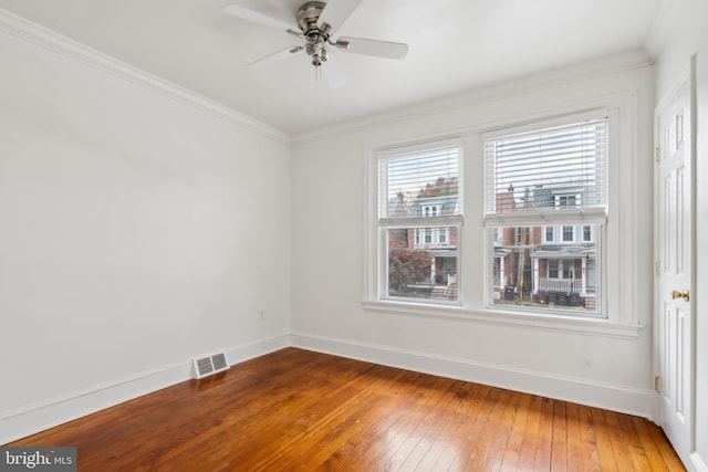 spare room with hardwood / wood-style flooring, ceiling fan, and crown molding