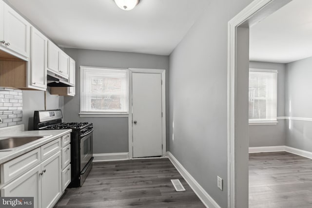 kitchen featuring white cabinetry, sink, dark wood-type flooring, tasteful backsplash, and black range with gas stovetop