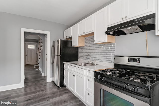 kitchen with sink, white cabinets, dark hardwood / wood-style floors, and appliances with stainless steel finishes