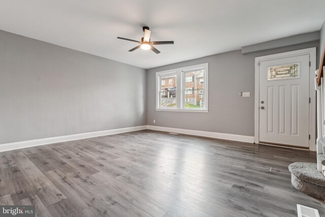 unfurnished living room featuring hardwood / wood-style floors and ceiling fan