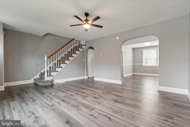 unfurnished living room with ceiling fan and hardwood / wood-style floors