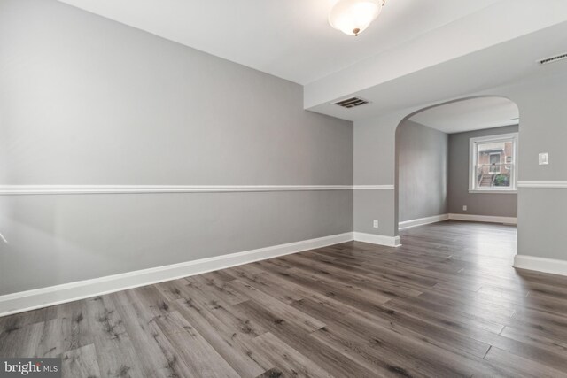 spare room with wood-type flooring