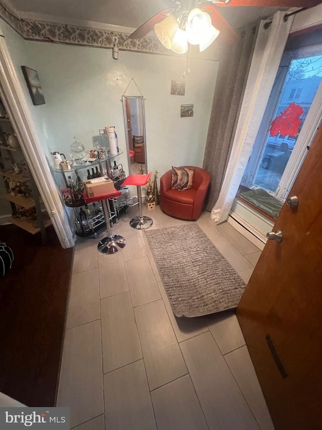 sitting room with tile patterned flooring and ceiling fan