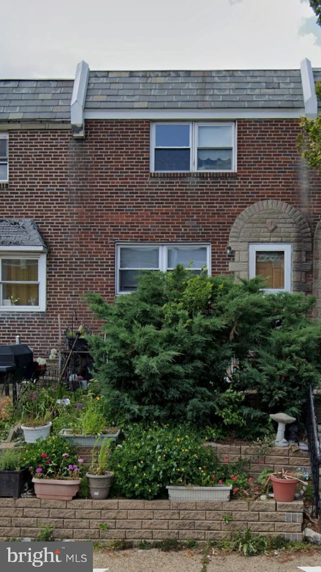 6412 Akron St, Philadelphia, PA 19149 - view of front of property featuring a high end roof, brick siding, and mansard roof