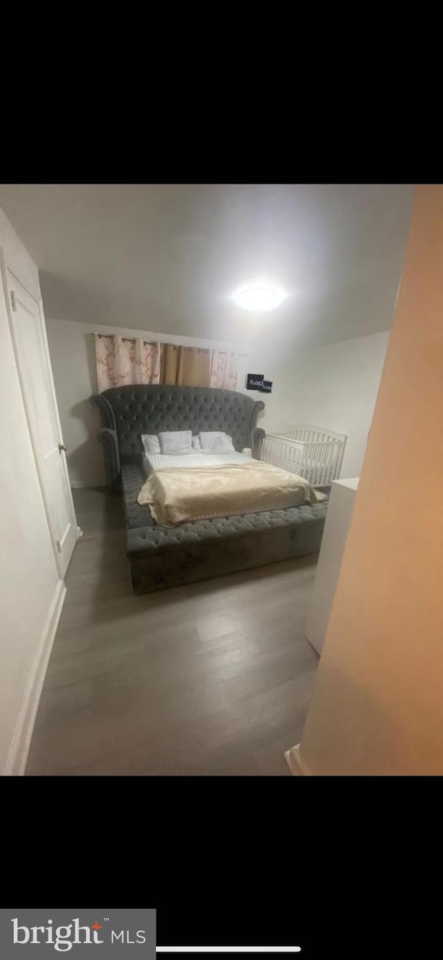 bedroom featuring dark hardwood / wood-style flooring