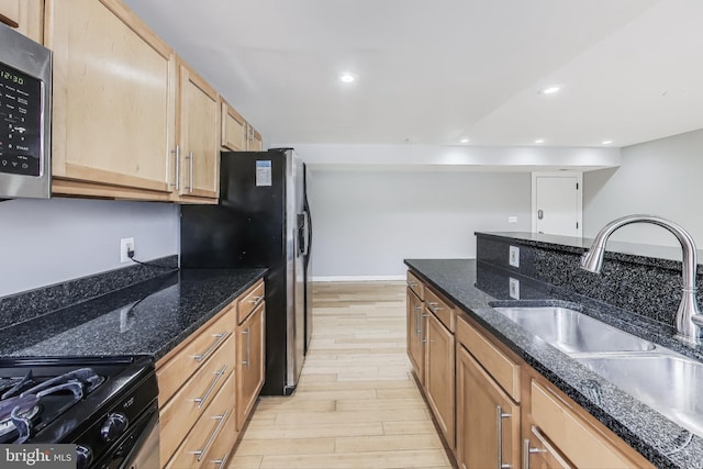 5045 Call Pl SE Unit 102, Washington, DC 20019 - kitchen with a sink, appliances with stainless steel finishes, light wood-type flooring, dark stone counters, and recessed lighting