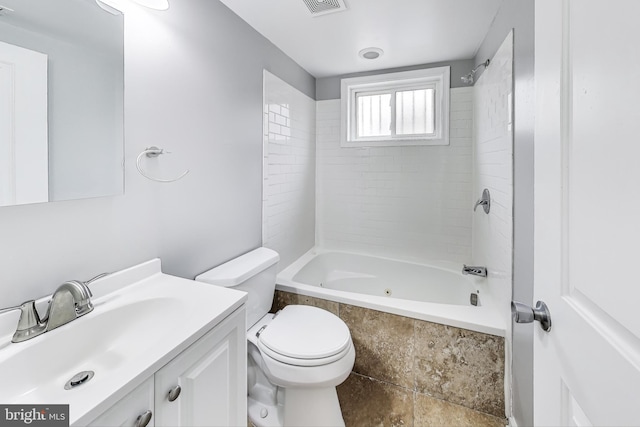 full bathroom with vanity, toilet, and tiled shower / bath