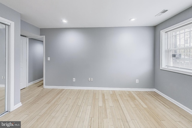 spare room with light hardwood / wood-style flooring