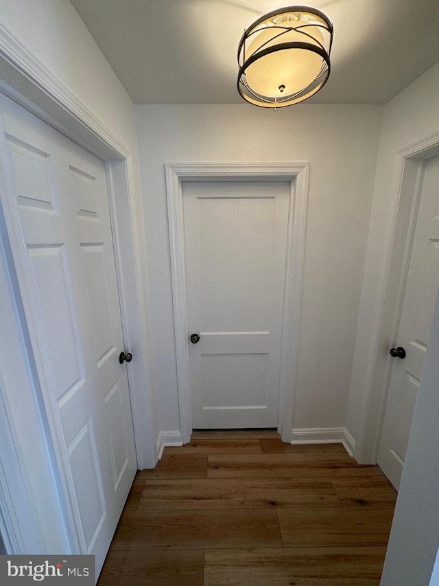 corridor with wood-type flooring