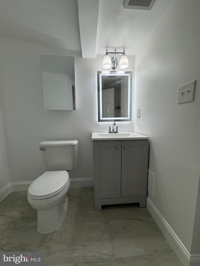 bathroom with vanity and toilet