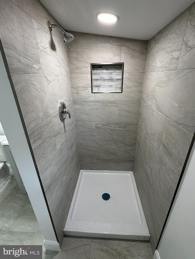 bathroom with a tile shower