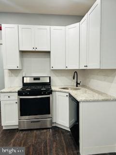 kitchen with white cabinets, dark hardwood / wood-style flooring, sink, and stainless steel stove