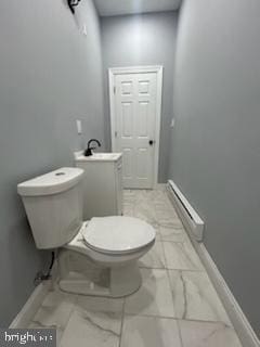 bathroom with sink, a baseboard radiator, and toilet