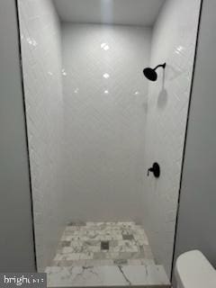 bathroom featuring toilet and walk in shower