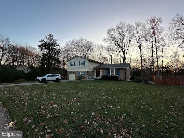 view of front facade featuring a garage and a lawn