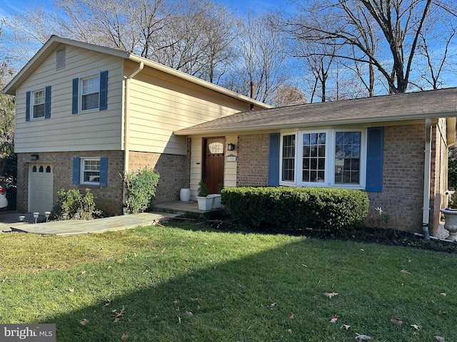 tri-level home with a garage and a front lawn