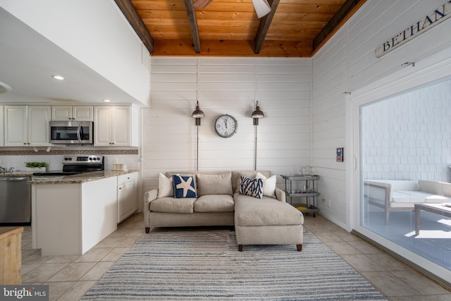 living room with beam ceiling, light tile patterned flooring, and wood ceiling