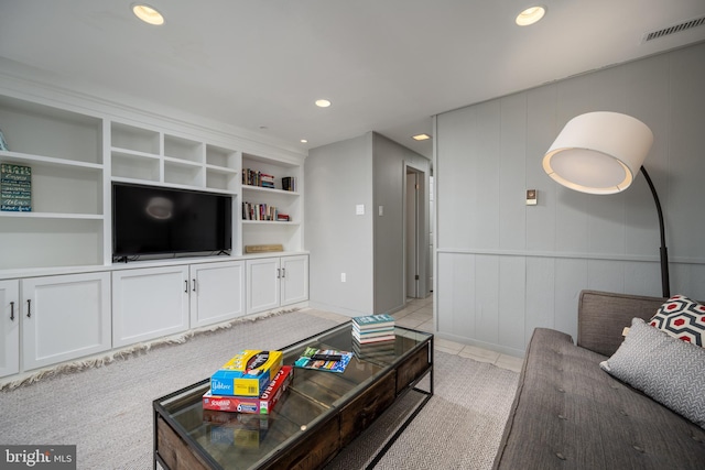 carpeted living room with built in features