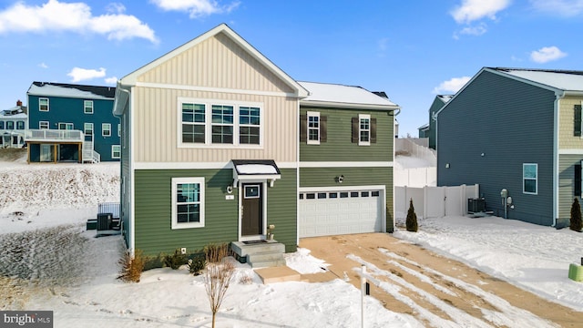 view of front of house with a garage and central AC unit