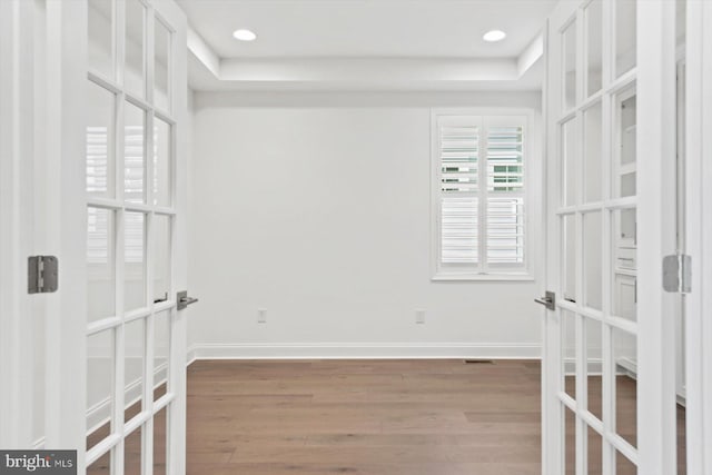 empty room with french doors and hardwood / wood-style floors